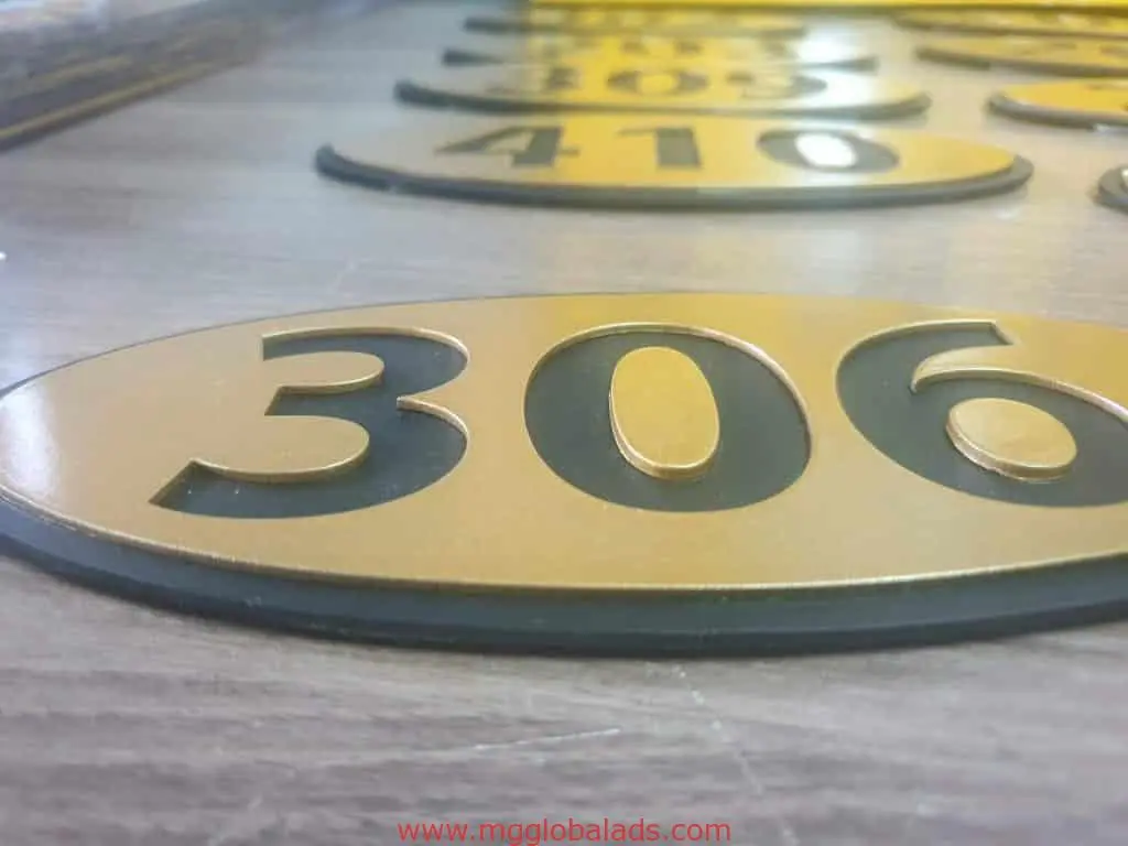 Hotel room number signage in gold and black, number 306, on wood in Makati by M&G Global Ads.