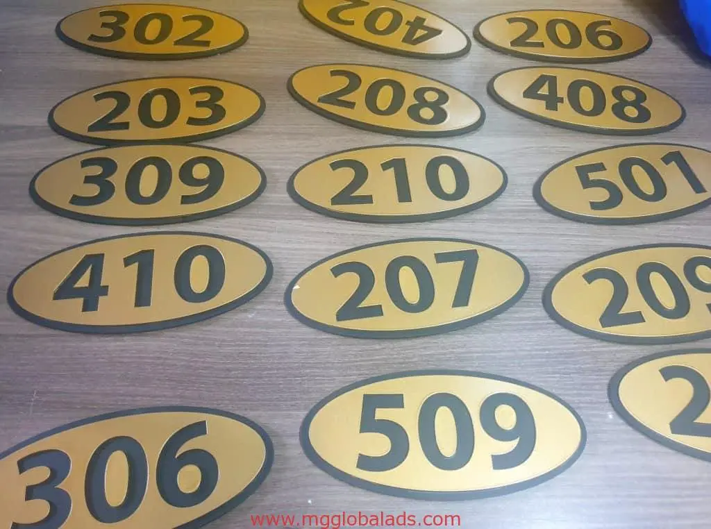 Building room number signage plaques, gold with black numbers, for Quezon City. Custom signs by M&G Global Ads.