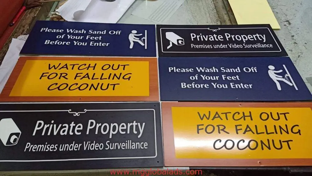 Acrylic safety and information signs for resort, Makati—falling coconuts, sand washing, surveillance—by M&G Global Ads.