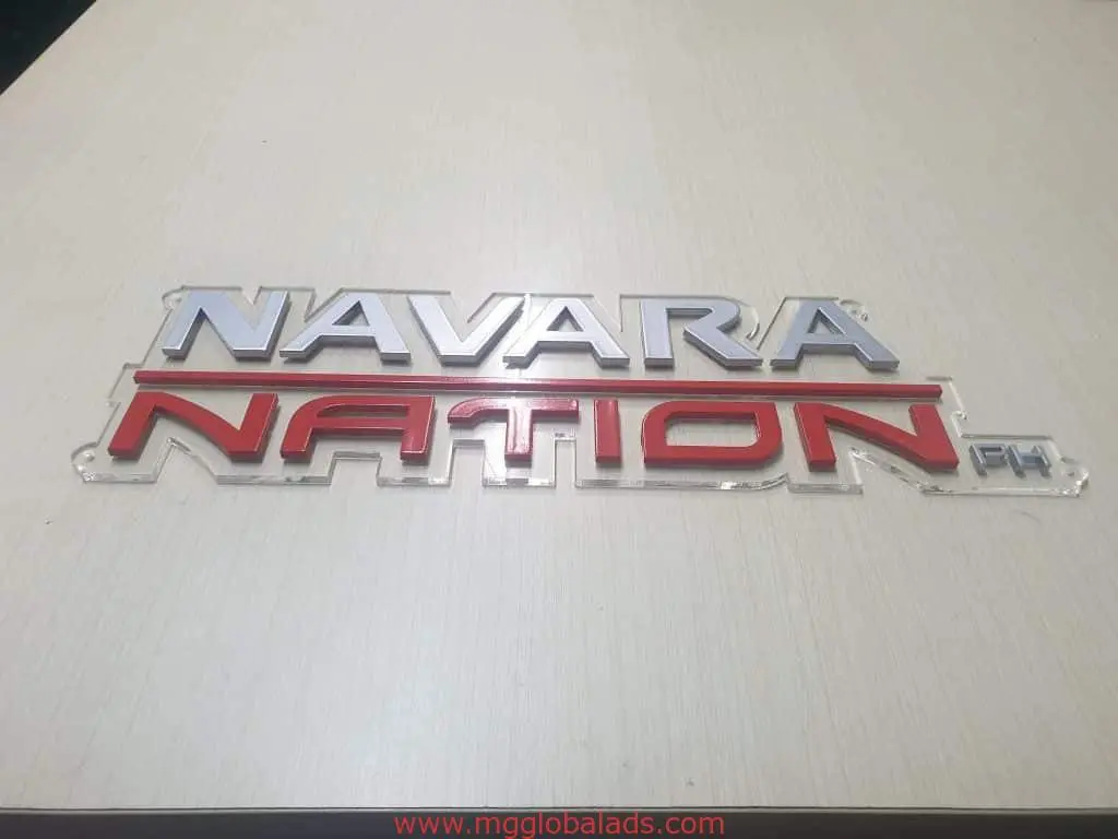 Outdoor metallic signage for NAVARA NATION PH in Makati, bold silver and red letters on wood, by M&G Global Ads.