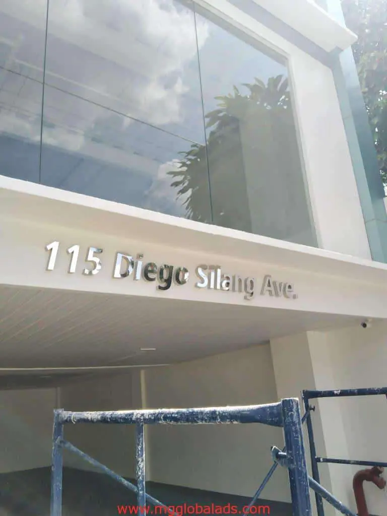 Address outdoor signage in metallic letters for 115 Diego Silang Ave, visible in Makati, by M&G Global Ads.
