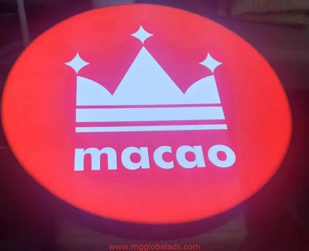 Indoor circular metallic signage for Macao with glowing red and white crown in Makati by M&G Global Ads.