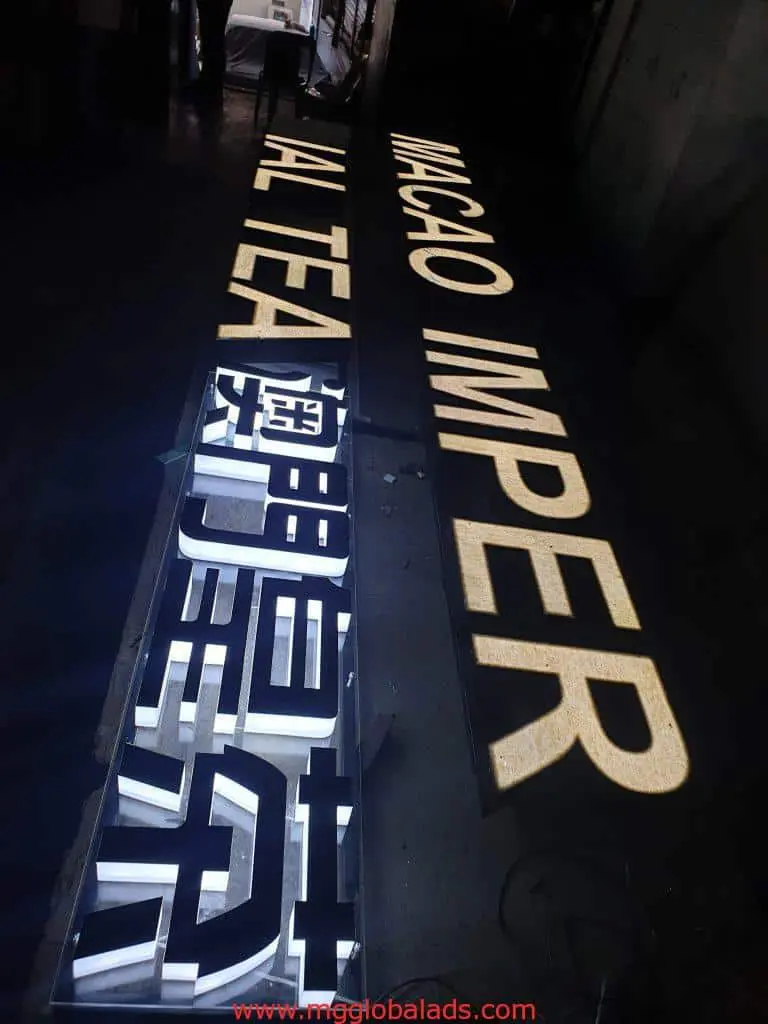 Illuminated indoor signage for MACAO IMPER AL TEA with Chinese text, metallic letters glowing, in BGC by M&G Global Ads.