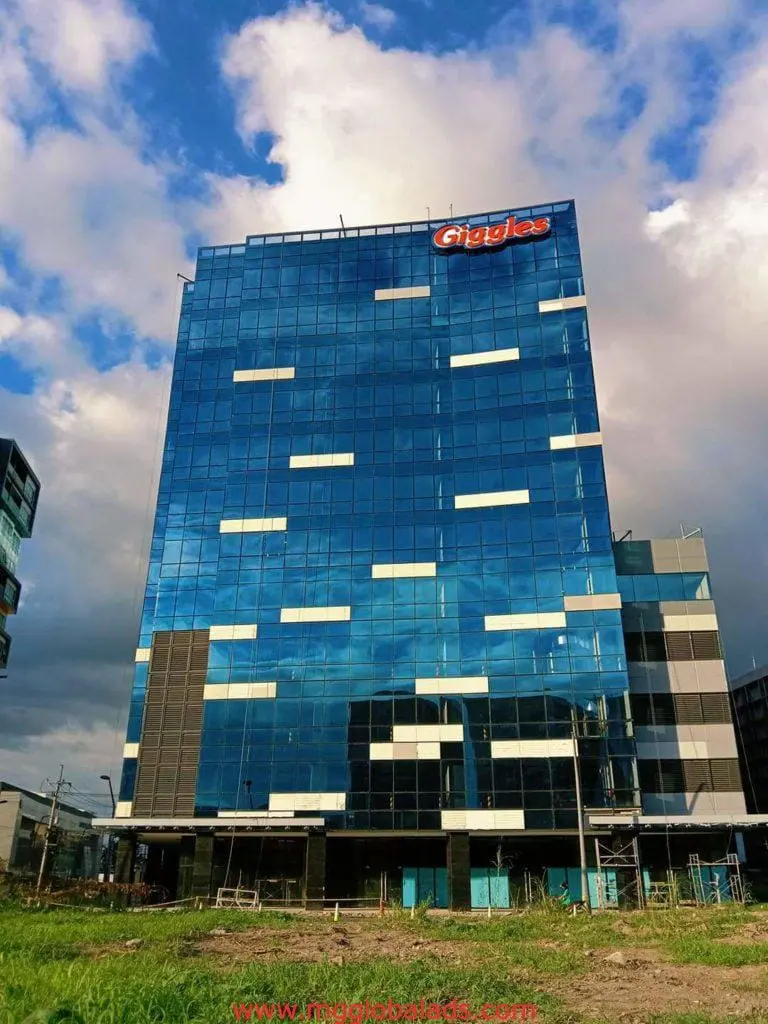 Giggles building signage for client Giggles on a modern glass office in Quezon City by M&G Global Ads.