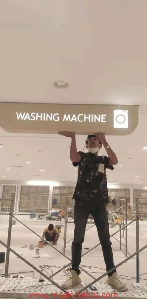 Acrylic indoor signage installation for laundry shop, WASHING MACHINE design, in a Makati commercial space by M&G Global Ads.
