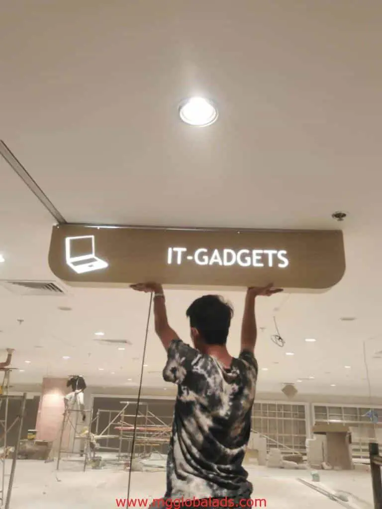 LED signage for IT-GADGETS with laptop icon, held up inside construction site in Makati, by M&G Global Ads.