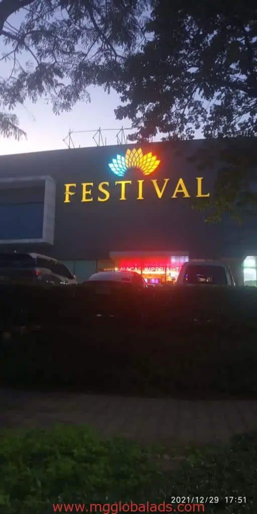 Festival custom outdoor building signage, neon signs, and acrylic storefront sign in Quezon City at dusk by M&G Global Ads.