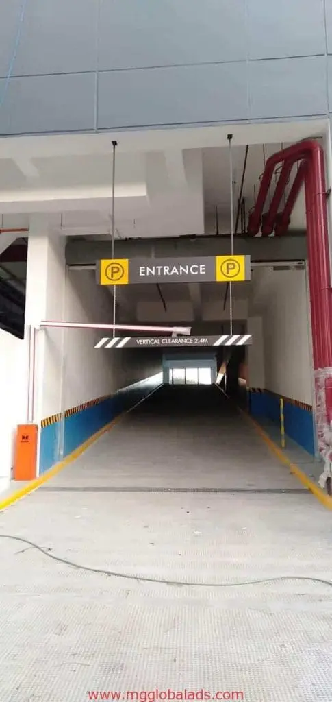 Yellow metallic entrance sign and parking symbols at garage, safety markings, Mandaluyong location by M&G Global Ads.