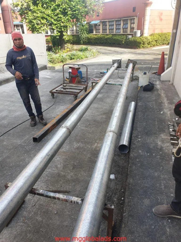 LED signage installation with workers and tools in front of a building in Ortigas, Metro Manila by M&G Global Ads.