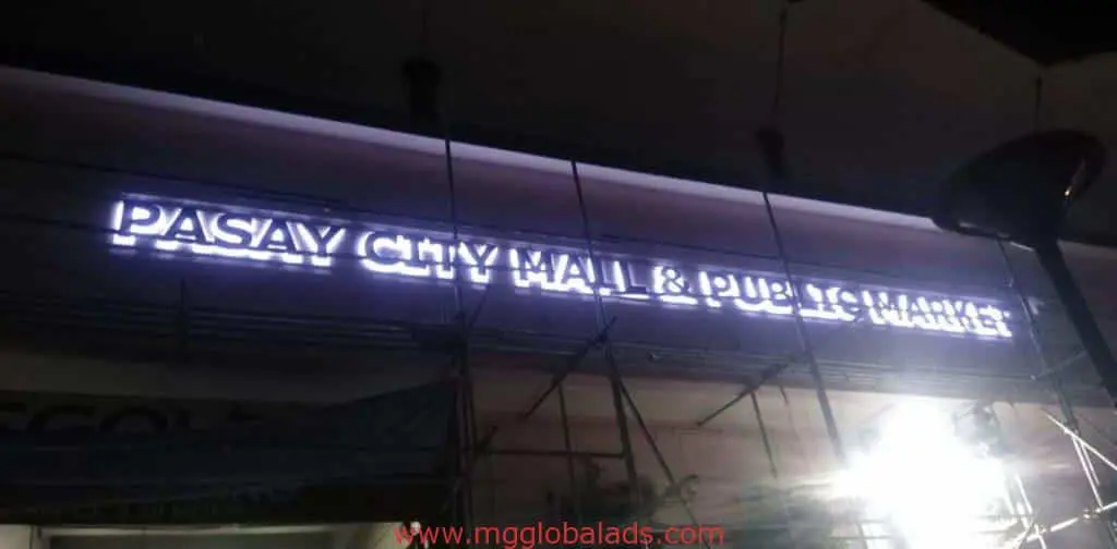 Illuminated metallic mall signage for Pasay City Mall & Public Market in Quezon City at night, by M&G Global Ads.