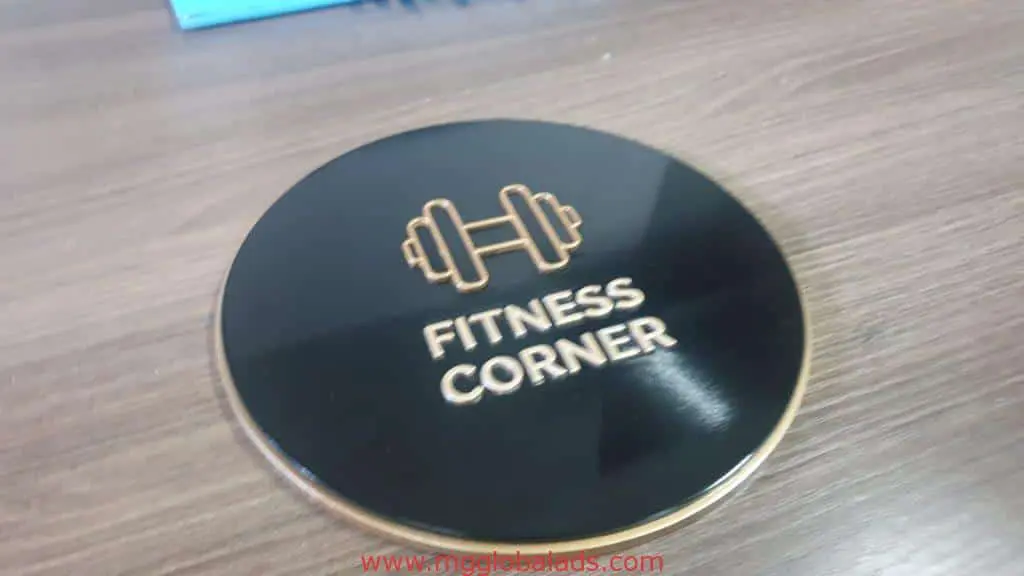 Indoor round black signage for FITNESS CORNER with gold dumbbell, Ortigas location, by M&G Global Ads.