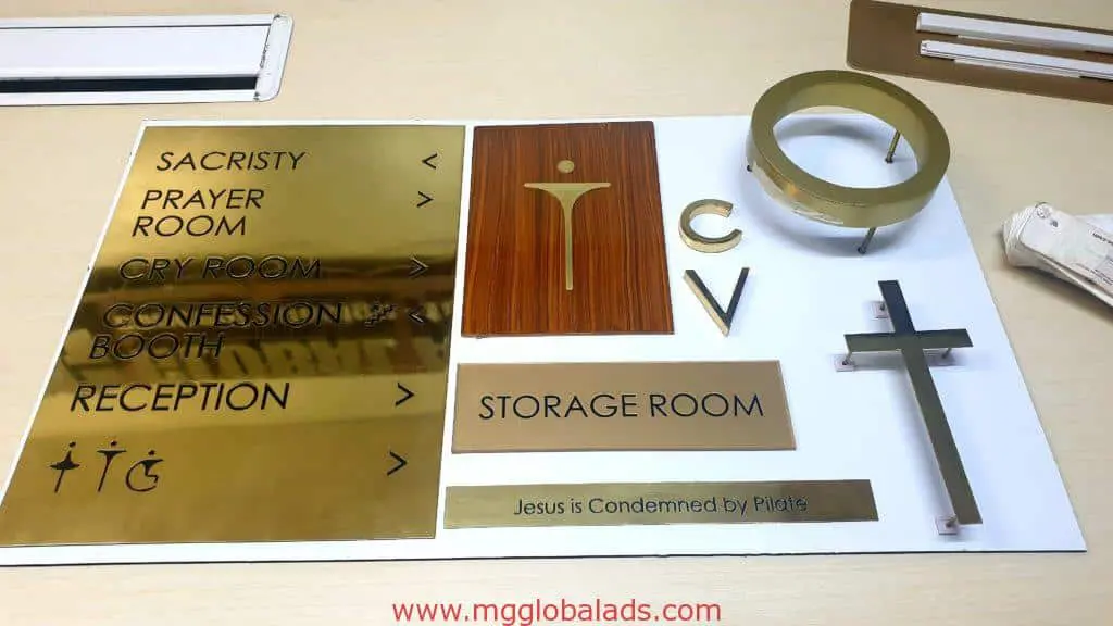 Church signage samples for Catholic clients, gold and wood plaques in Makati with Christian icons, by M&G Global Ads.