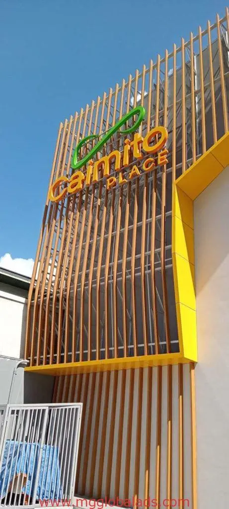 Outdoor storefront signage for Caimito Place in Mandaluyong on a modern facade, vertical slats, by M&G Global Ads.