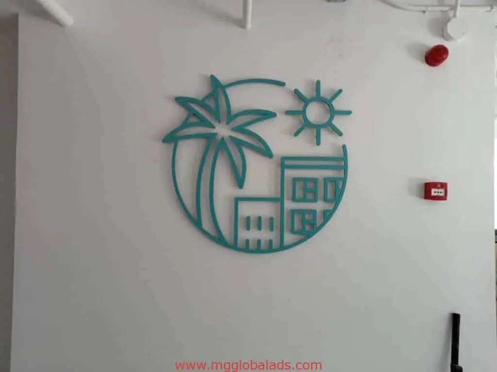 Outdoor metallic signage for client displayed in Ortigas with minimalist teal palm tree, sun, and buildings. by M&G Global Ads.