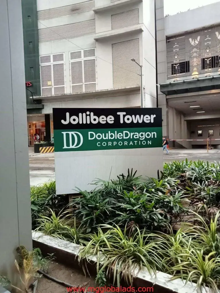 Outdoor building signage for Jollibee Tower and DoubleDragon Corporation in Ortigas, cityscape view, by M&G Global Ads.