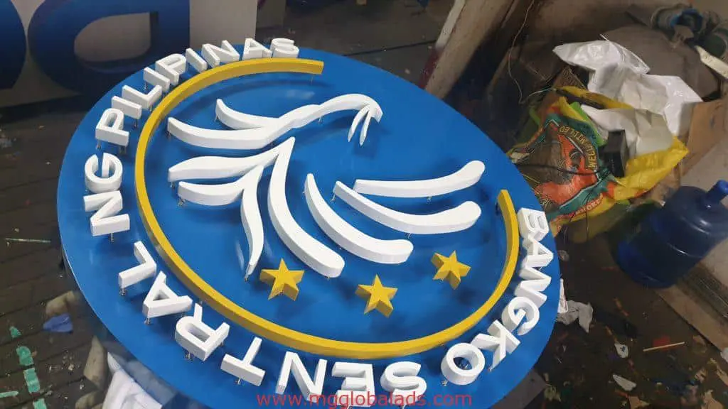 Bangko Sentral ng Pilipinas round metal signage in workshop, Makati location fabrication by M&G Global Ads.