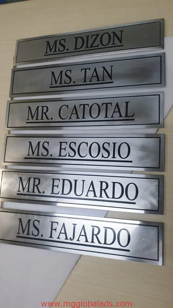 Metallic indoor nameplate signage with black text for office in Makati, names displayed, by M&G Global Ads.