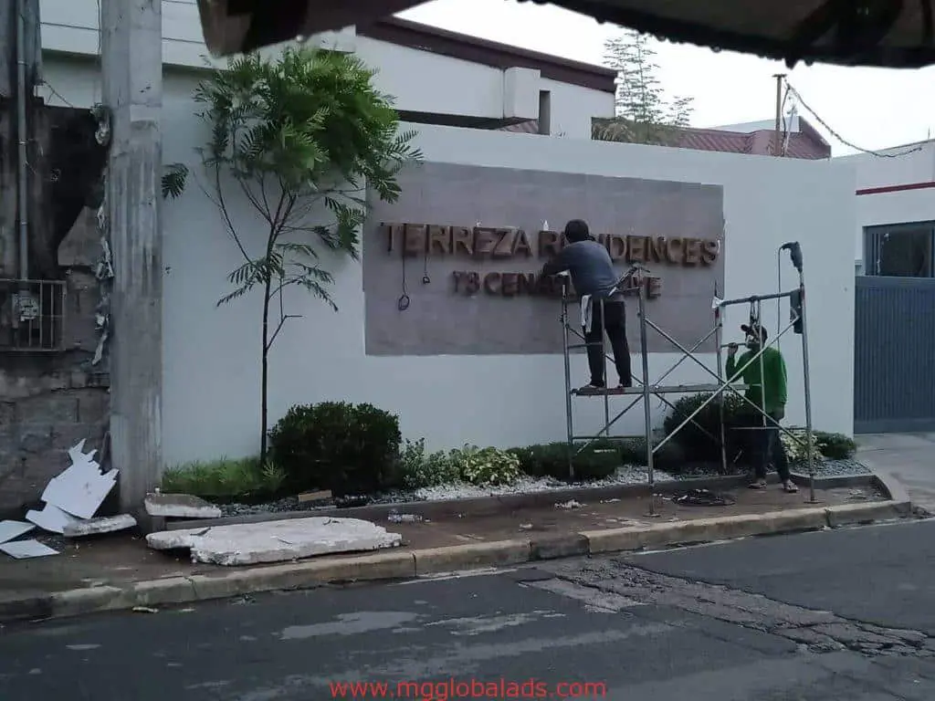 Acrylic signage installation for Terreza Residences client, sidewalk setup in Quezon City by M&G Global Ads.
