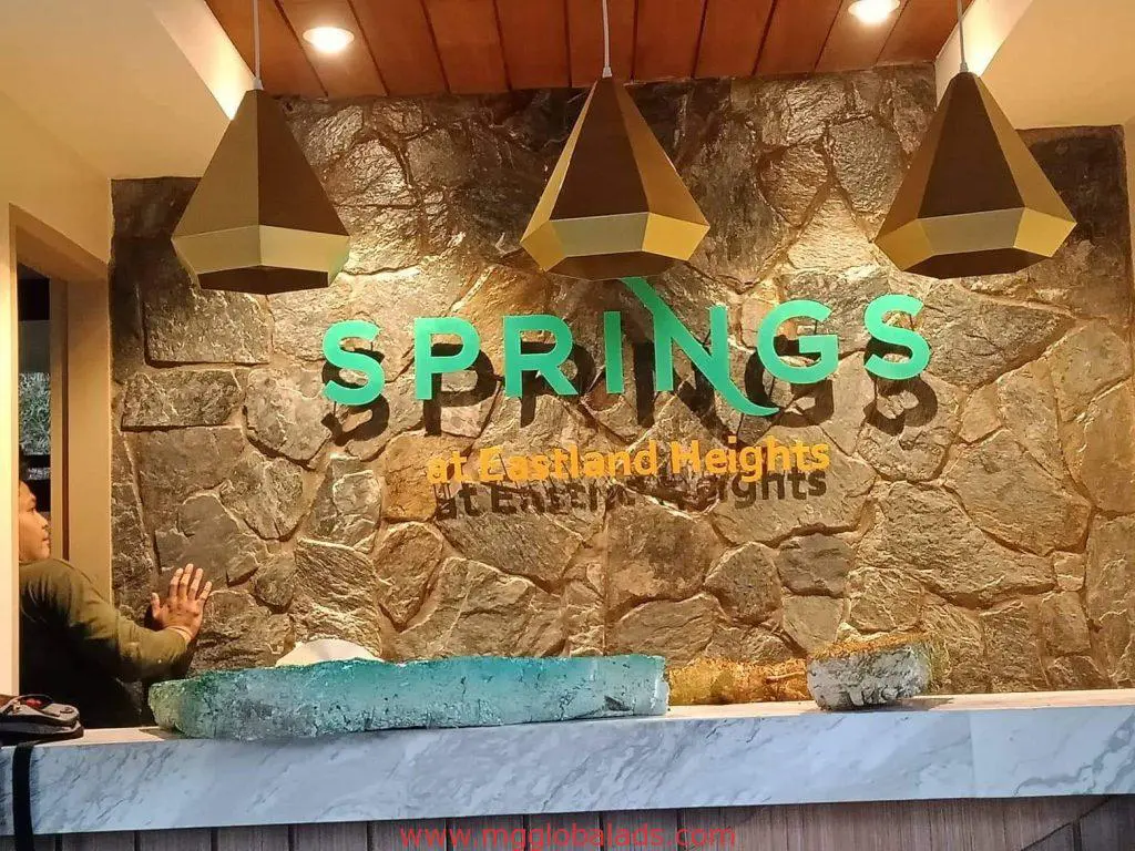 Lobby indoor building signage for Springs at Eastland Heights in Quezon City, with desk, by M&G Global Ads.