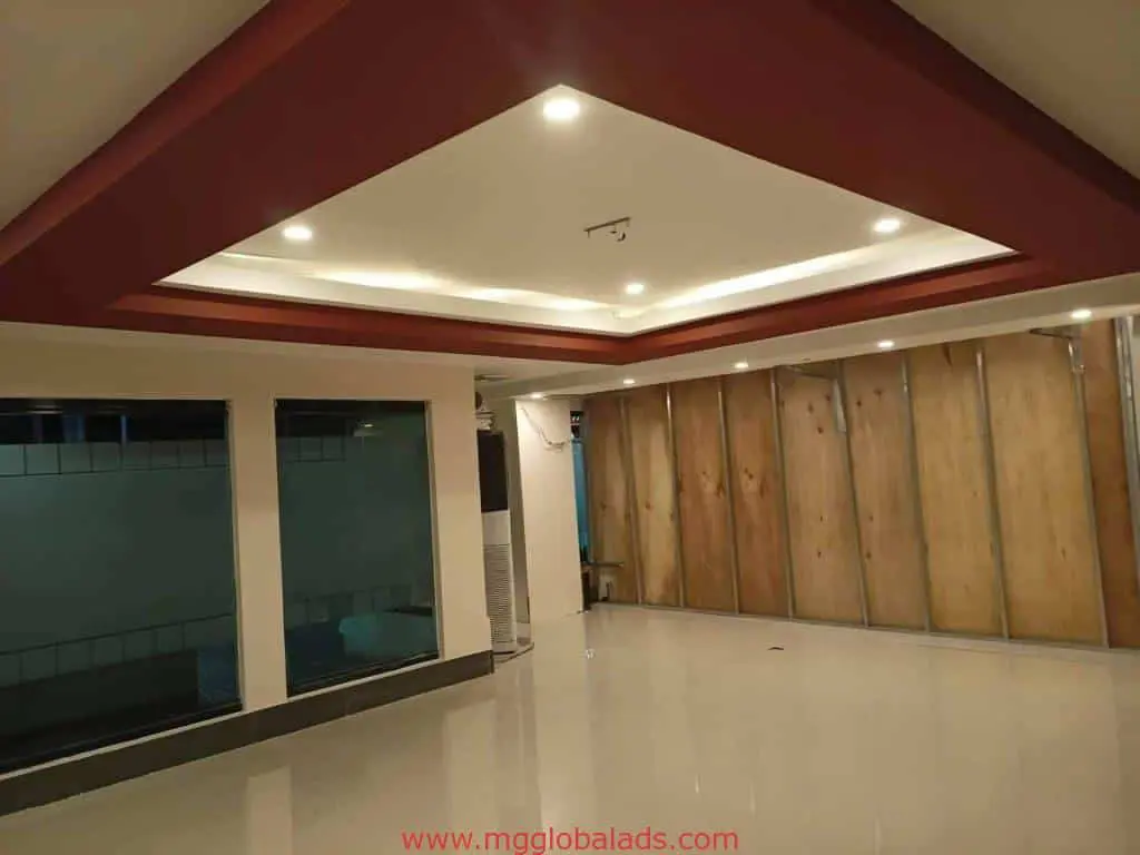 Room with glossy white tiles, wood panel wall for metallic business signage in Makati, modern space by M&G Global Ads.