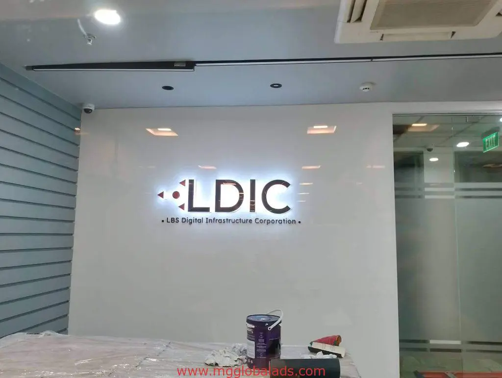 LDIC LBS Digital Infrastructure Corporation metallic office signage in Makati with painting tools, by M&G Global Ads.