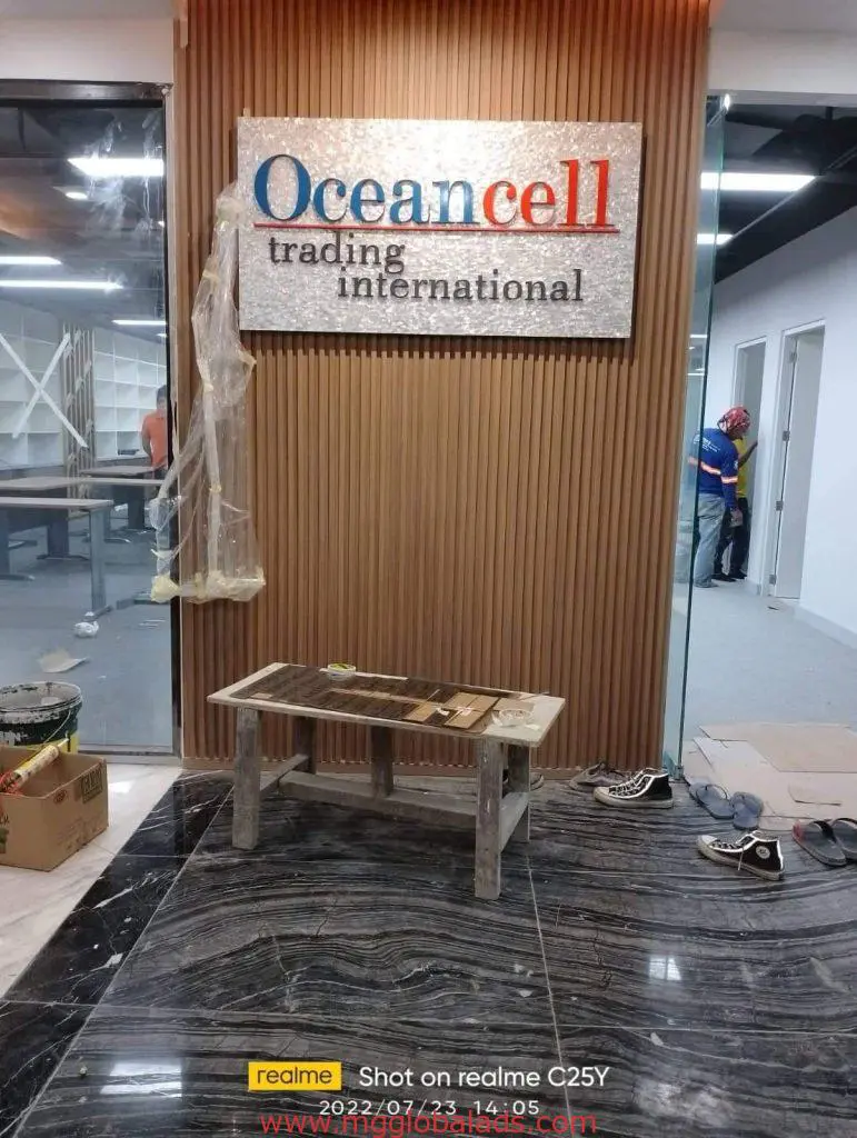 Metal indoor signage for Oceancell Trading International in Makati, wood wall, workers, by M&G Global Ads.