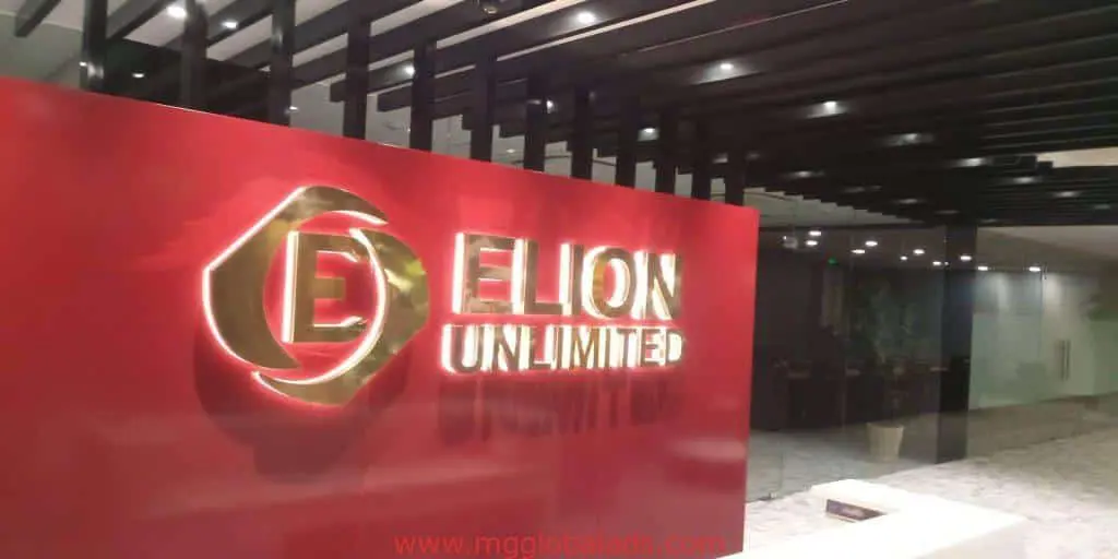 ELION UNLIMITED acrylic office signage in a modern lobby with glossy red wall in BGC by M&G Global Ads.