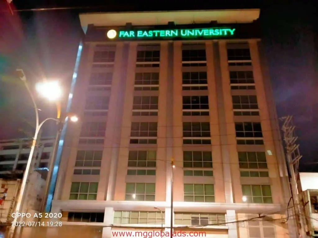 Illuminated building signage Far Eastern University on tall, well-lit structure in Ortigas at night by M&G Global Ads.