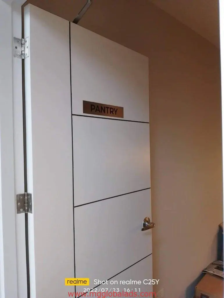 Metallic pantry door signage in Makati, white door, silver handle, partial beige wall inside by M&G Global Ads.
