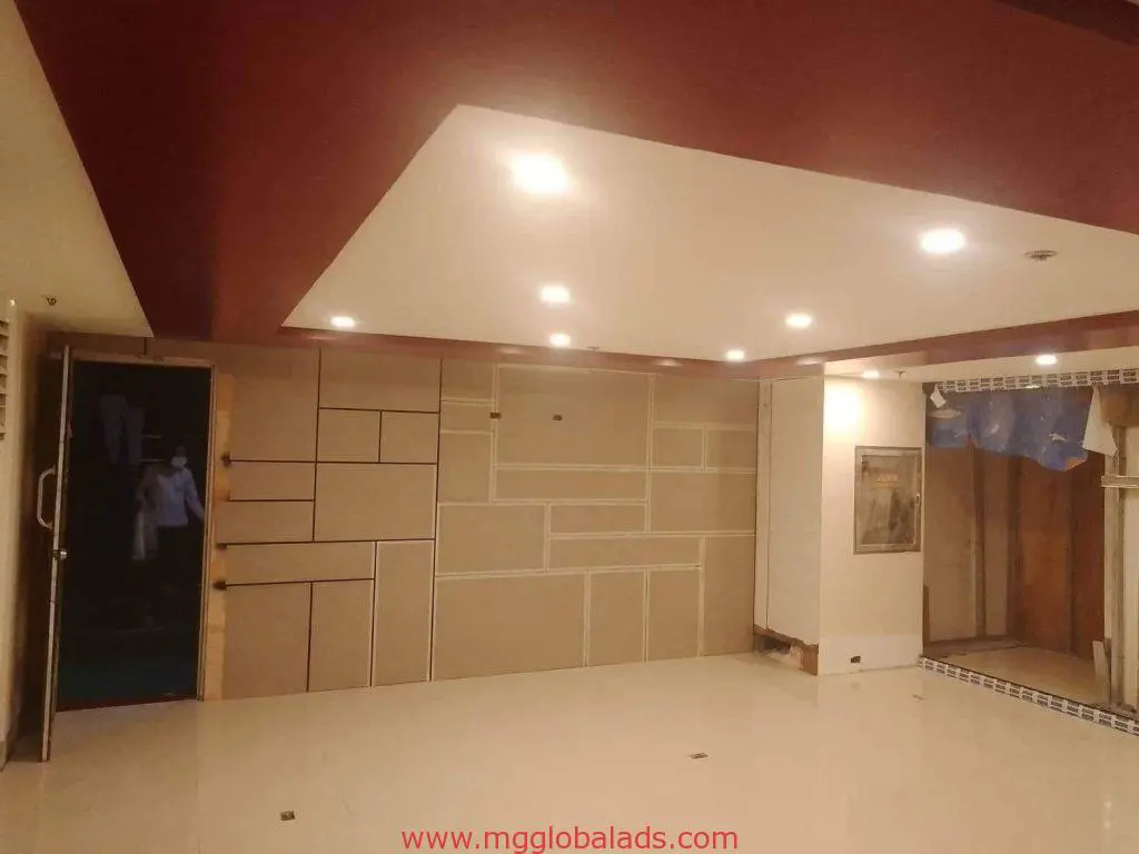 Modern empty room with geometric panels, glossy floor, and LED signage feature in Makati showroom, by M&G Global Ads.