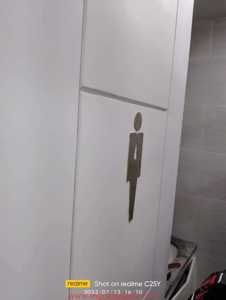 Acrylic male restroom indoor signage installed on white cabinet door in Makati with tiled wall and countertop by M&G Global Ads.
