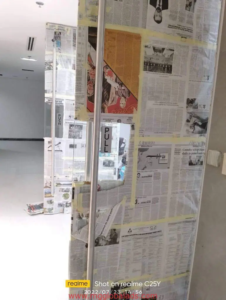 PULL door signage on glass door with newspaper cover at a Makati storefront, timestamp and phone watermark shown, by M&G Global Ads.