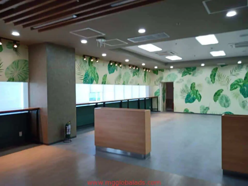 Modern LED signage in a spacious reception area with wood and greenery, Makati location, by M&G Global Ads.