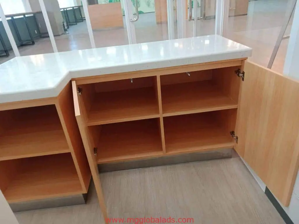 Building signage display cabinet with white countertop and open shelves, for office interiors in Makati by M&G Global Ads.