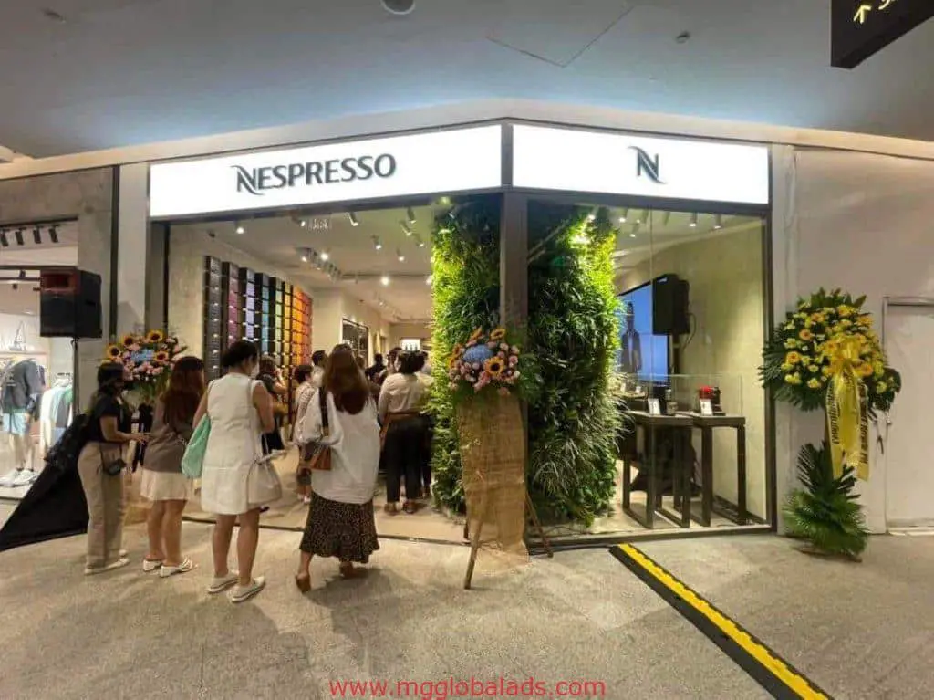 Nespresso LED signage at mall entrance in BGC, with flower decor, green wall, and colorful displays. By M&G Global Ads.
