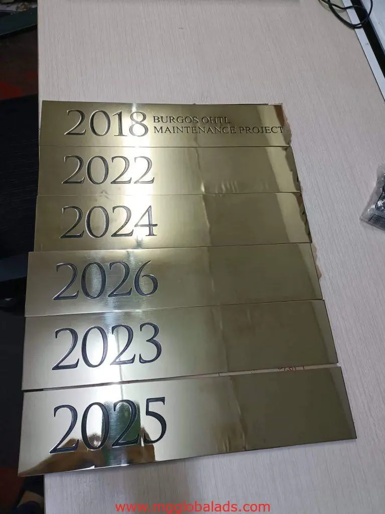 Gold metal corporate plaques signage for BURGOS OTHL MAINTENANCE PROJECT, years 2018–2026, Ortigas by M&G Global Ads.