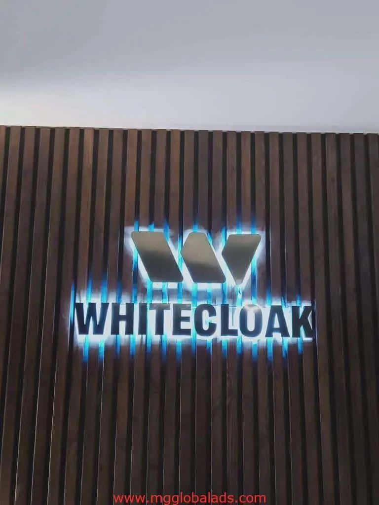 Acrylic signage for WHITECLOAK on wooden slat wall with blue edge lighting in Ortigas, by M&G Global Ads.