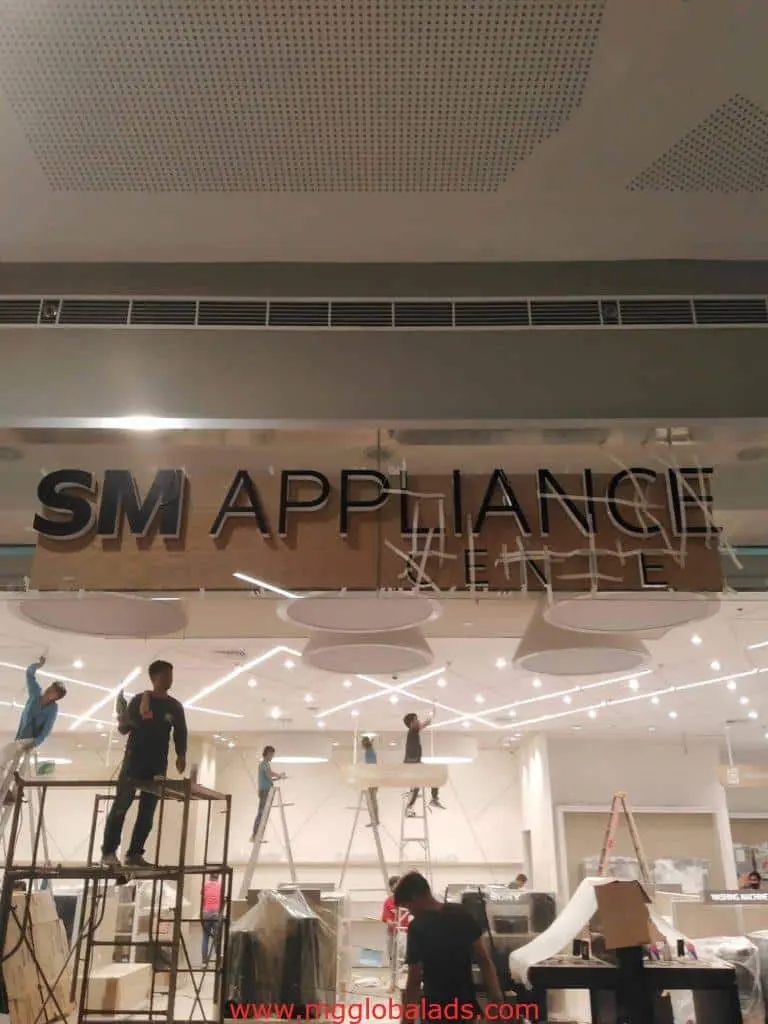 Metallic building signage installation for SM APPLIANCE in Quezon City commercial space by M&G Global Ads.