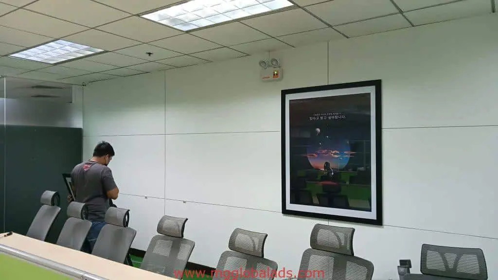 Sleek acrylic office signage in Mandaluyong with framed space poster, modern chairs, and bright lighting by M&G Global Ads.