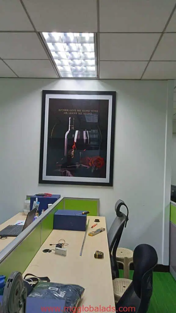 Office with desks and chairs, LED signage lighting on wine bottle art in Makati, by M&G Global Ads.