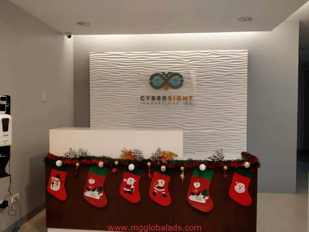 Acrylic signage for Cybersight Innovations Inc. at reception desk with Christmas stockings, Ortigas, by M&G Global Ads.