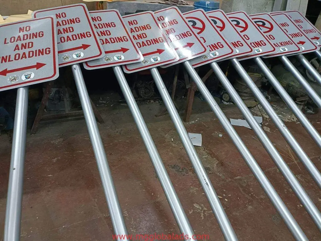 No Loading and Unloading and No Parking metal signages in Makati, arranged indoors with metal poles by M&G Global Ads.