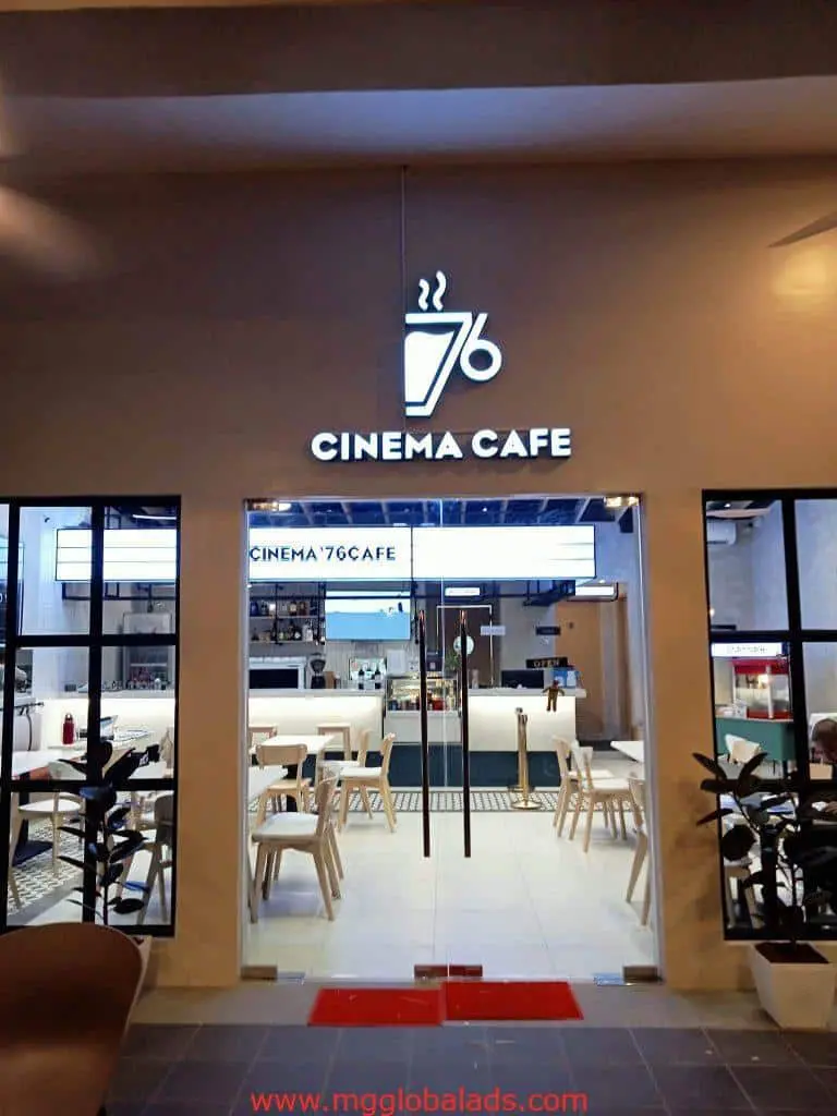 LED signage for Cinema 76 Cafe in Quezon City, coffee cup logo visible above modern cafe entrance, by M&G Global Ads.