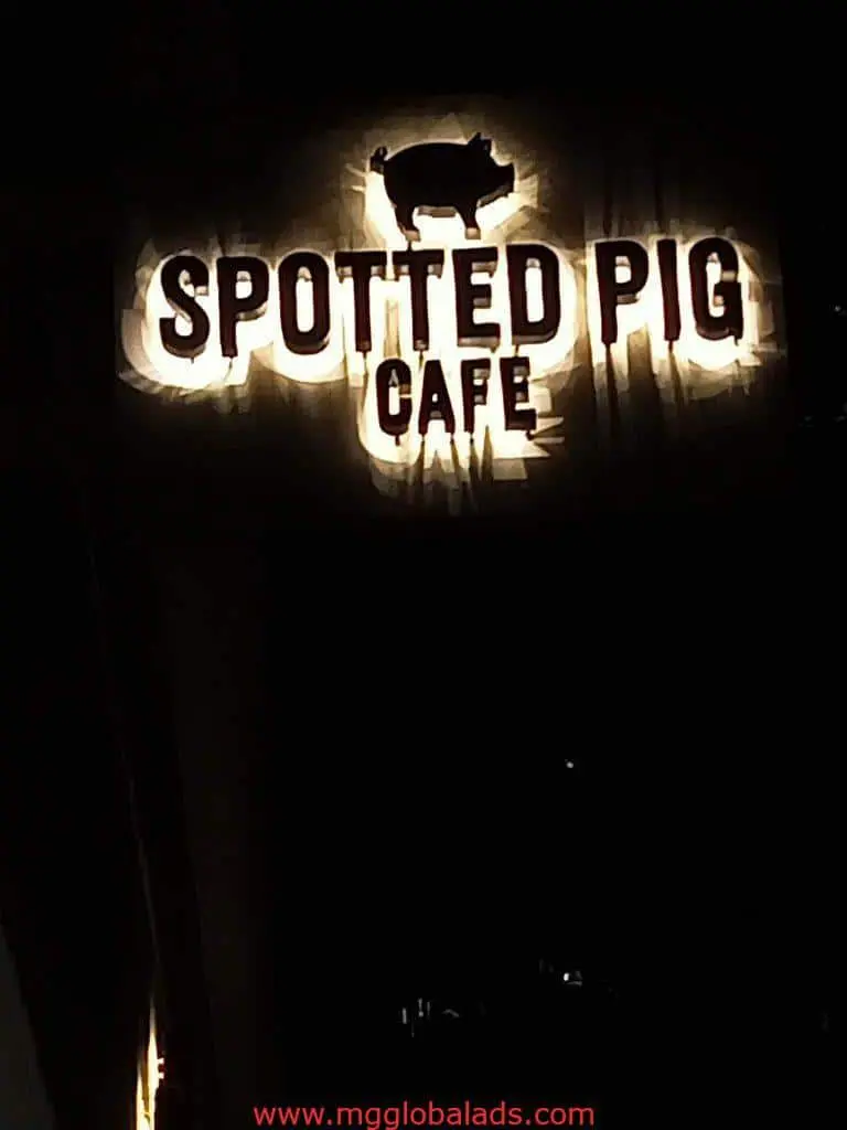 Metallic café signage for Spotted Pig Café with pig silhouette at night in BGC, Metro Manila by M&G Global Ads.
