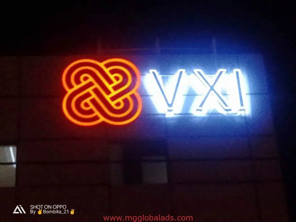 Neon acrylic signage for VXI with orange intertwined logo, displayed on a building in BGC by M&G Global Ads.