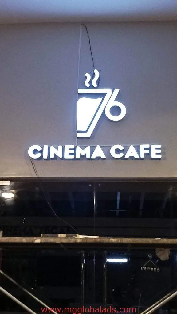 Indoor signage for CINEMA CAFE with steaming cup logo on gray wall in Ortigas by M&G Global Ads.