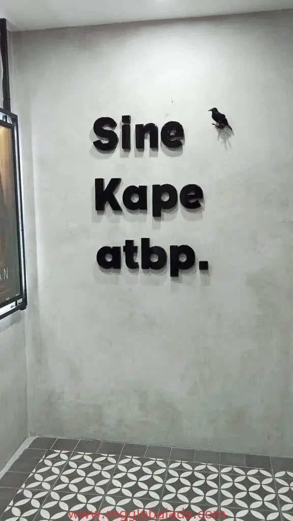Black 3D indoor signage for Sine Kape atbp. in Makati with bird detail; geometric tile floor. By M&G Global Ads.