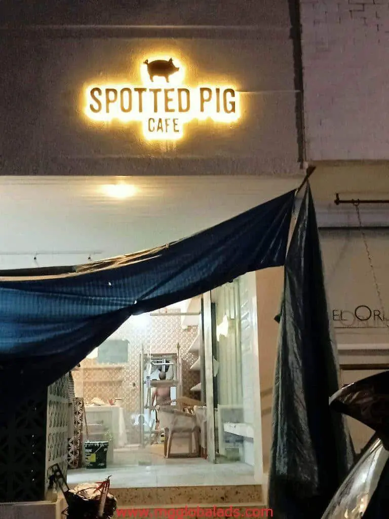 Metallic lighted cafe signage for Spotted Pig Cafe in Quezon City, night view with blue fabric and visible tables by M&G Global Ads.