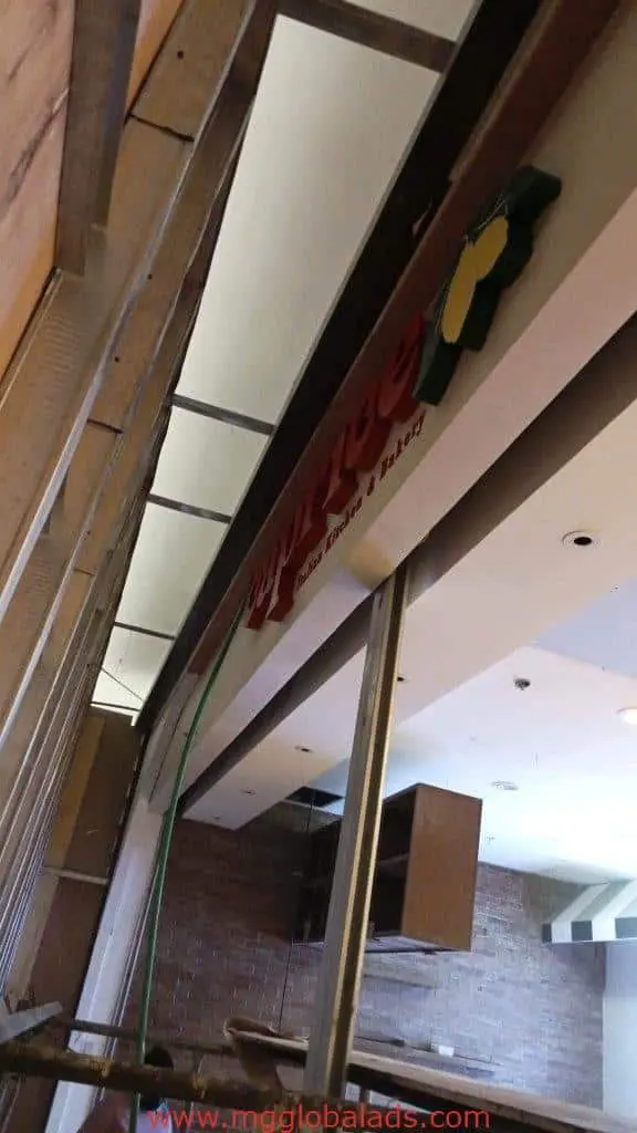 Acrylic signage for Yellow Cab Pizza Co. in Makati, storefront under construction with materials visible by M&G Global Ads.