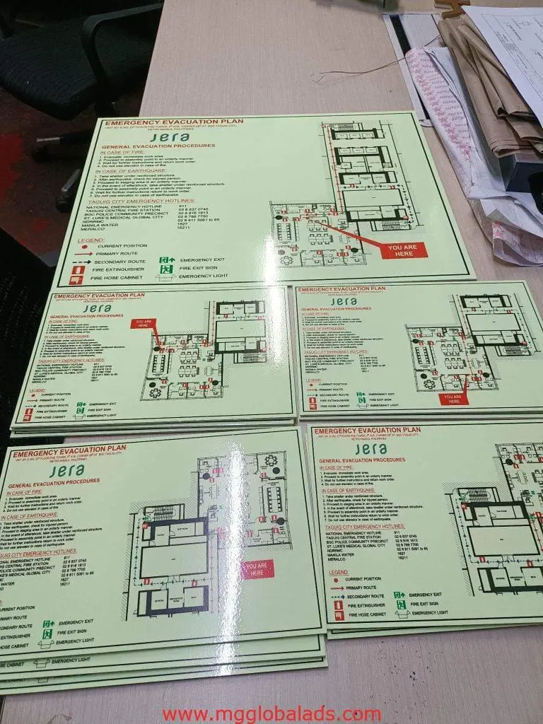 Indoor emergency evacuation plan signage for Jera in Makati, showing floor plans and safety icons by M&G Global Ads.